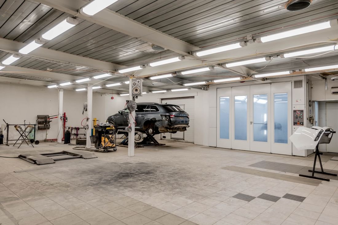 Modern AXLON Autos repair bay with a vehicle on the lift