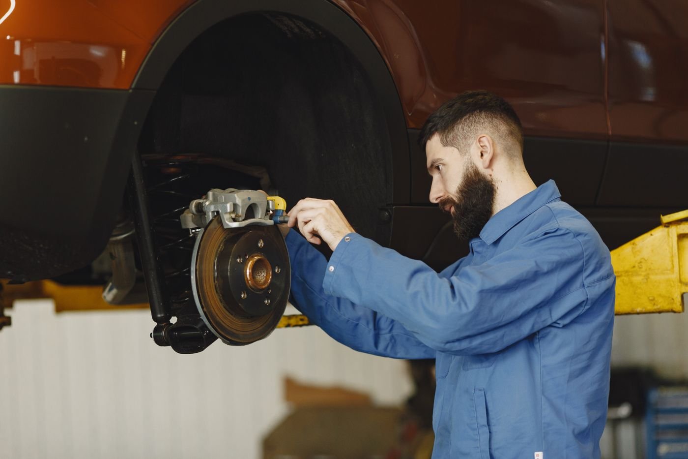 Mechanic performing brake repair on a car