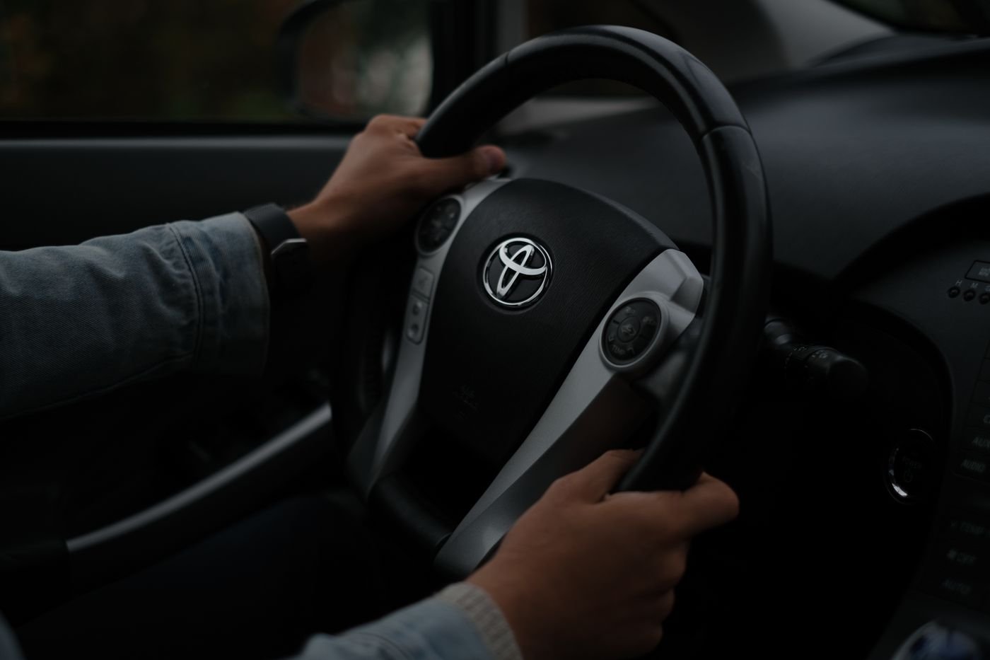 Driver's hands on a car steering wheel