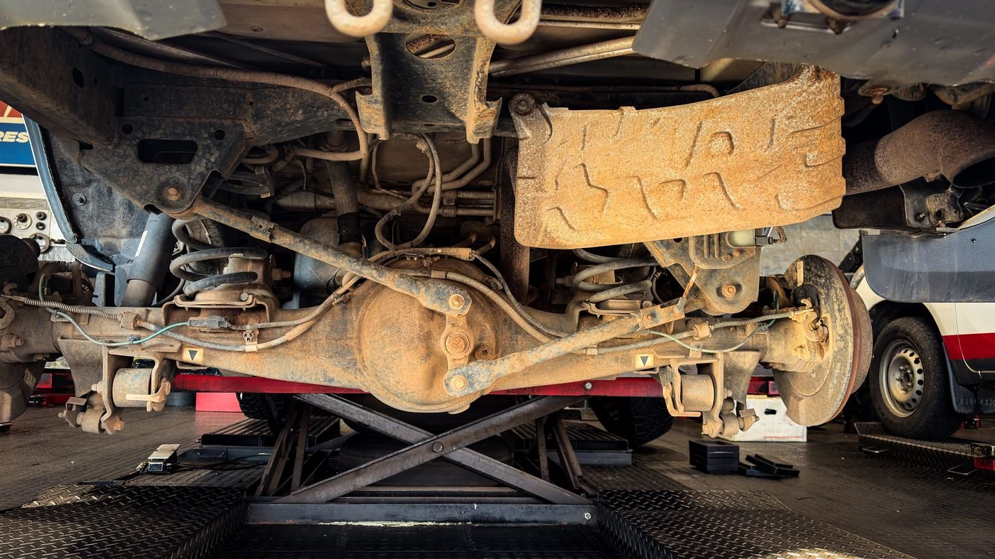 Worn, rusty suspension system during repair
