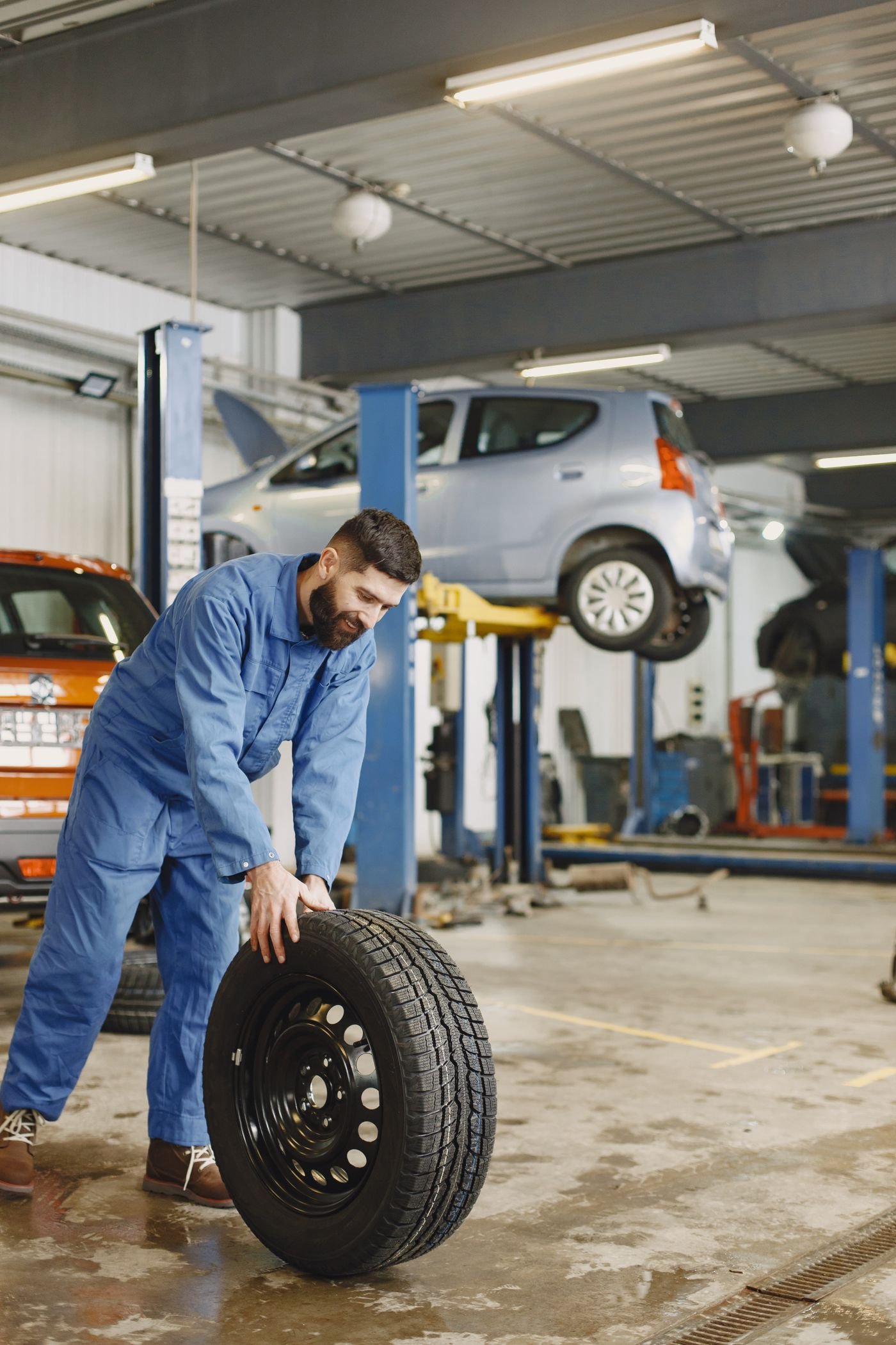 Technician handling a new car tire